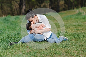 Kiss and hugs of mom and son. Mom and son walk in the summer park. Family holiday and togetherness. Happy mother`s day