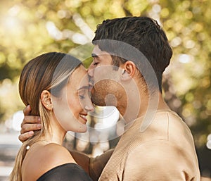 Kiss, love and romance with a couple bonding outdoor during a date on a summer day. Happy, trust and smile with a young