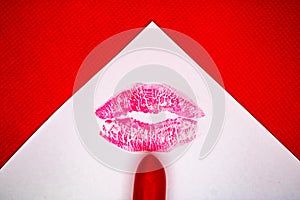 Kiss mark and the red lipstick on the white paper with the red background - Image