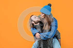 kiss me sweetie. christmas fun. knitted fashion. man and woman in sweater hat and scarf. happy family wear warm clothes