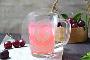Kissel with cherries in a glass on an old wooden background, traditional russia or poland drink, berry jelly, mousse, summer pink