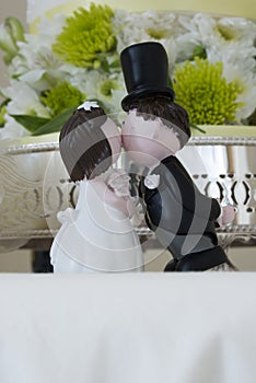 Kissing bride and groom figurines