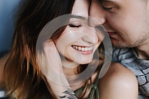 Kissing couple portrait. Young couple deeply in love sharing a romantic kiss, closeup profile view of their faces