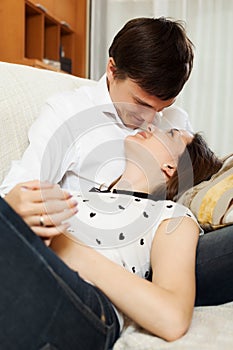 Kissing couple on sofa