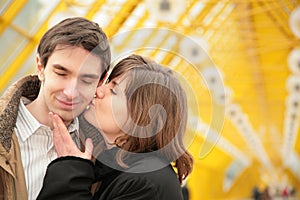 Kissing couple on yellow bridge