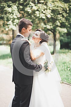 Kissing wedding couple in spring nature close-up portrait