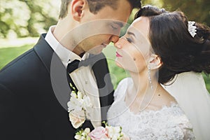 Kissing wedding couple in spring nature close-up portrait