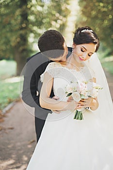 Kissing wedding couple in spring nature close-up portrait