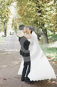 Kissing wedding couple in spring nature close-up portrait