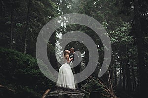 Kissing wedding couple in spring nature close-up portrait