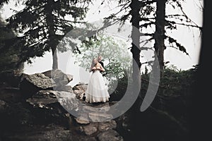 Kissing wedding couple in spring nature close-up portrait