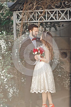 Kissing wedding couple in spring nature close-up portrait