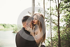 Kissing wedding couple in spring nature close-up portrait