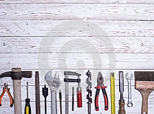 Kit of assorted tools for construction work. on a white wooden board. copy space