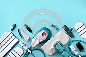 Kit of modern professional steam cleaners on blue background. Top view, flat lay. Banner with copy space. Cleaning service concept