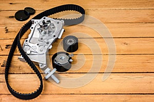 Kit of timing belt with rollers and pump on a wooden table