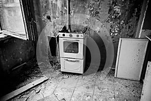 Kitchen of abandoned apartment in ghost town Pripyat in Chernobyl Exclusion Zone, Ukraine. Black and white tone