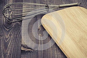 Kitchen accessories nimbus and board/kitchen accessories nimbus and board on a dark wooden background. Top view. With copy space