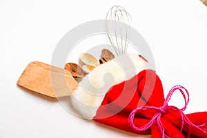 Kitchen accessories or tools. Christmas gift concept. Kitchen accessories or kit of kitchenware packed in big red sock