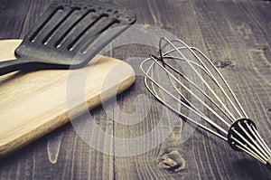 Kitchen accessories on a wooden background/kitchen accessories on a wooden background. Selective focus. Toned