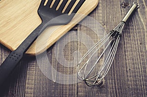 Kitchen accessories on a wooden background/kitchen accessories on a wooden background. Toned. Top view