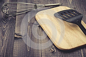 Kitchen accessories on a wooden dark table/kitchen accessories on a wooden dark table. Toned. With copy space