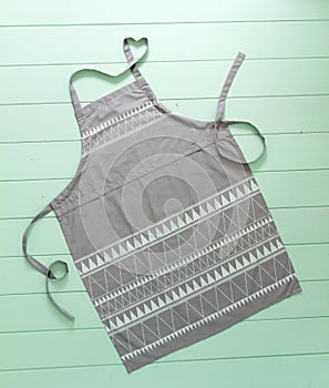 Kitchen apron of gray color on turquoise background photo