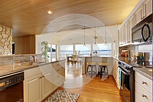 Kitchen area with paneled ceiling and hardwood floor