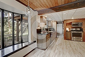 Kitchen area with red brick wall and built in appliances