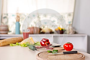 Kitchen background with vegetables, knife and boards