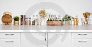 Kitchen bench shelf with various herbs, spices, utensils on white