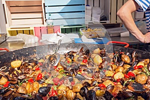 Kitchen with big plate of cooking fresh food with oysters, potato and spices. Seafood market dish