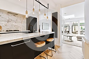 a kitchen with black and white counter tops and wooden