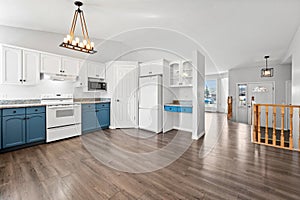 Kitchen with blue cabinets and a white refrigerator