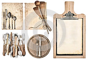 Kitchen board, aged recipe paper and vintage cutlery