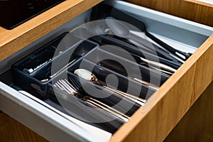 Kitchen box with cutlery. Spoons, forks, knives