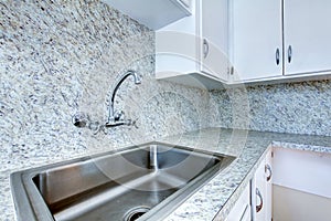 Kitchen cabinet with steel sink and granite counter top