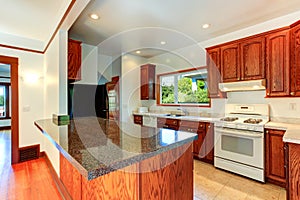 Kitchen cabinets with granite tops and white appliances