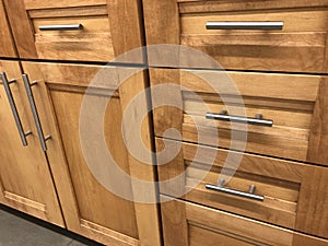Kitchen cabinets made of natural wood maple with chrome handles