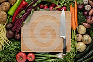 Kitchen Chef Knife with Fresh Vegetables on Wood Cutting Board