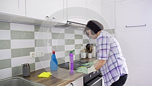 Kitchen cleaning, woman washing ceramic electric hob