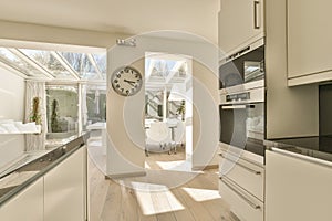 a kitchen with a clock in the middle of it