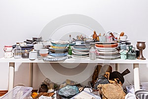 Kitchen clutter, utensils and kitchenware on a table. Concept of tidying and decluttering photo