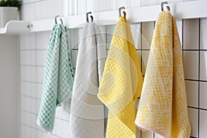 Kitchen colorful towels haning on rack. Generate AI photo