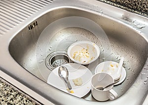 Kitchen conceptual image. Dirty sink with many dirty dishes.