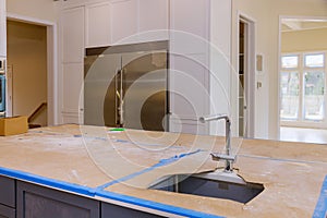 Kitchen contemporary with chrome fixture and white conter tops