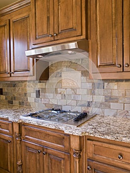 Kitchen cooktop and cabinets angle view