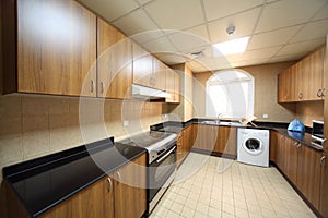 Kitchen with cupboards, washingmachine and cooker