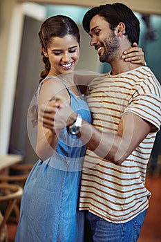 This kitchen is for dancing. an affectionate young couple dancing in their kitchen at home.