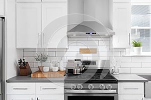 A kitchen detail with white cabinets and subway tile backsplash.